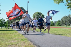 A group of people run in a line.