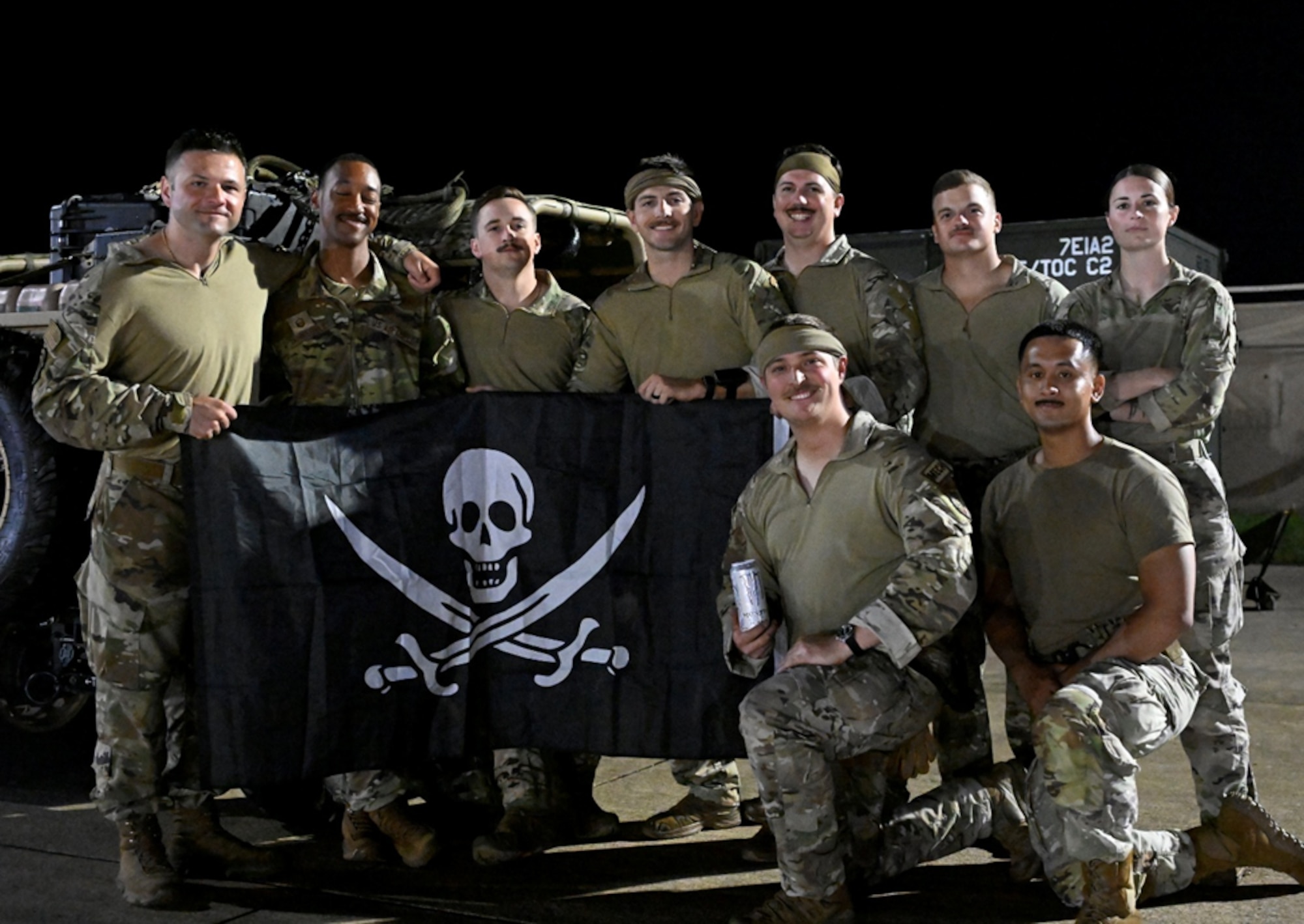 People pose with a flag.
