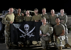 People pose with a flag.
