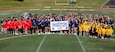 Students from Marine Corps Base Quantico’s Department of War Education Activity schools, U.S. Marines, and staff, pose for a group photo during the Presidential Fitness Test at Butler Stadium on MCB Quantico, Virginia, May 12, 2026. The Presidential Fitness Test consists of three fitness components that are designed to strengthen health, physical fitness, resilience, and establish lifelong healthy habits. The PFT also recognizes multiple levels of achievements, including the Presidential Fitness Award, National Fitness Award, Completion recognition and improvement. (U.S. Marine Corps photo by Lance Cpl. Lynsee Avila-Ramirez)
