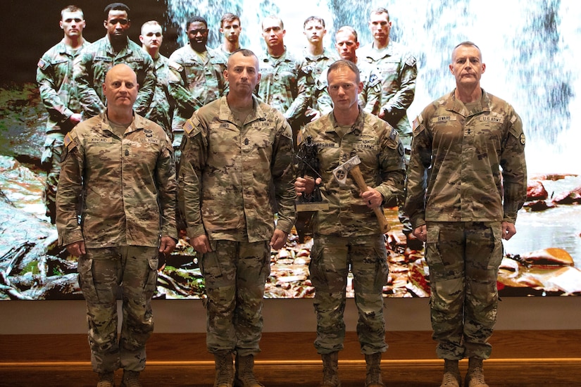 U.S. Army Staff Sgt. Frederic Newton poses for a photo with Major General James Seward, Command Sgt. Maj. James "Dusty" Jones, and Command Sgt. Maj. Aaron Kincaid, during the Region II Best Warrior Competition ceremony hosted by West Virginia National Guard, at Camp Dawson in Kingwood, West Virginia, on May 6, 2026. The annual competition tests participants on a range of warrior tasks, including physical fitness, marksmanship, and land navigation, to identify the top Soldier and noncommissioned officer who will advance to the National Best Warrior Competition. (U.S. Army National Guard photo by Spc. Ayla Cameron)
