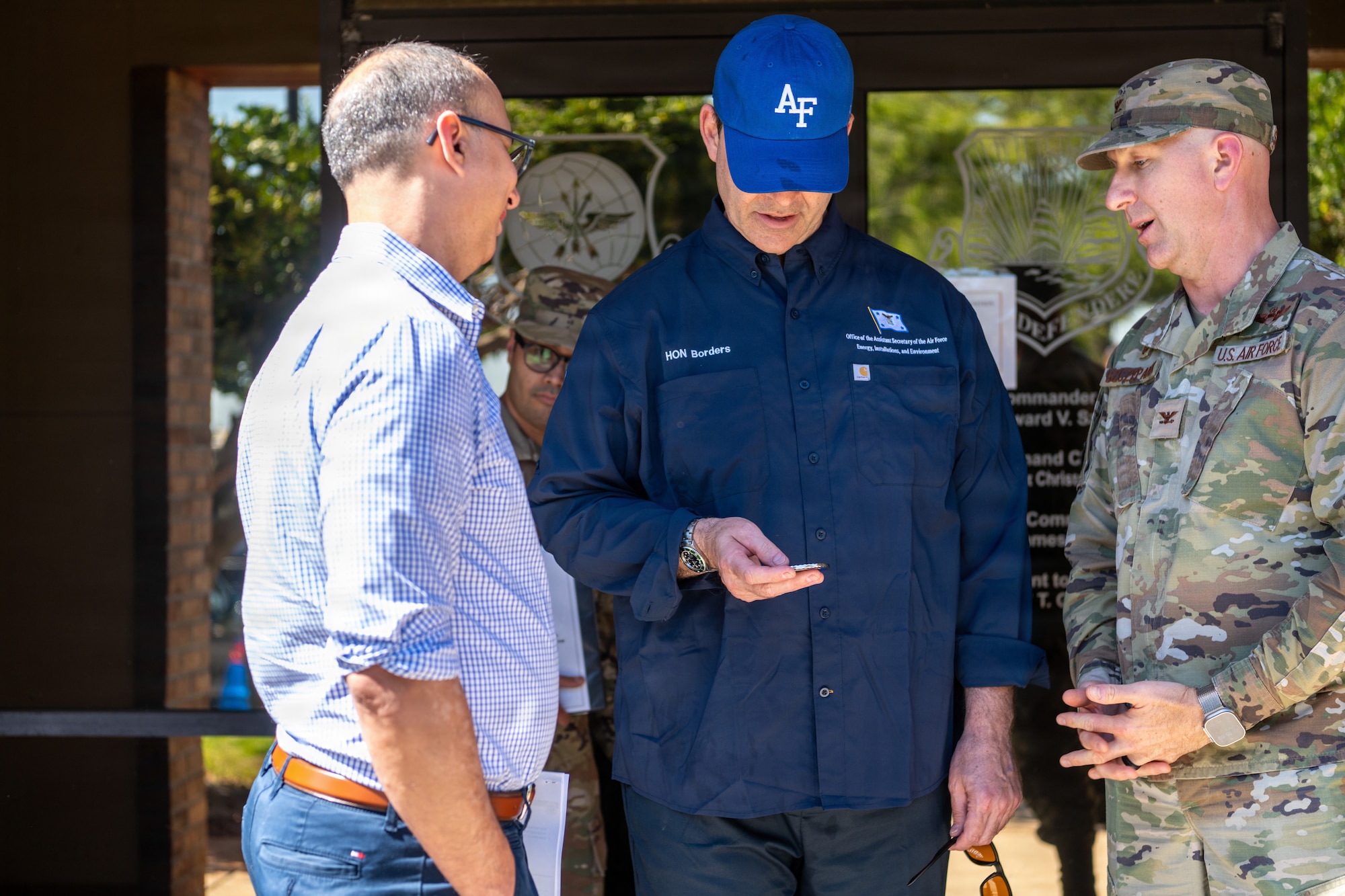 The Honorable Michael Borders, U.S. Assistant Secretary of the Air Force for Energy, Installations and Environment, receives a coin from Col. Edward Szczpanik, 6th Air Refueling Wing commander (right) at MacDill Air Force Base, Florida, April 15, 2026. Borders received the coin in recognition of his visit to review installation support for Airmen and the air refueling mission. (U.S. Air Force photo by Airman Micquill Davis)