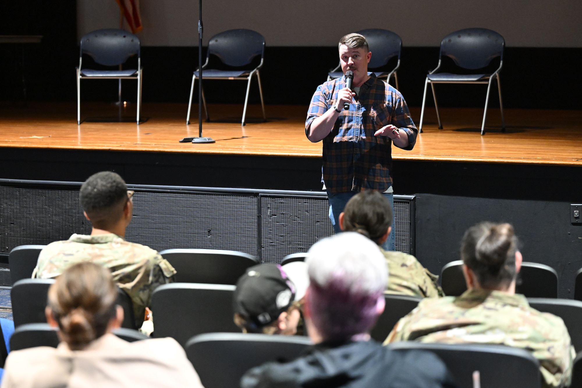 Man speaks to audience.