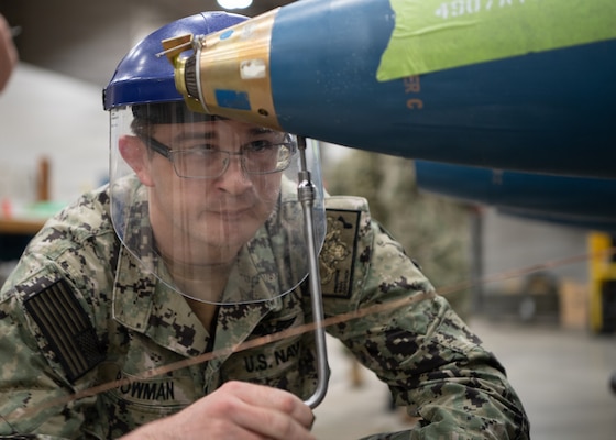 U.S. Navy Gunner’s Mate 1st Class Swade Bowman, assigned to Navy Reserve, Navy Munitions Command Pacific, Mine Assembly Unit Guam, attaches an arming device to an MK62 mine during a mine building training event at Naval Munitions Command Atlantic (NMCLANT) at Naval Weapons Station Charleston, May 6, 2026. The high-intensity training evolution was designed to evaluate personnel on their ability to safely, accurately, and rapidly assemble complex mine systems under simulated combat conditions. (U.S. Navy photo by Mass Communication Specialist 1st Class Matt Wright)