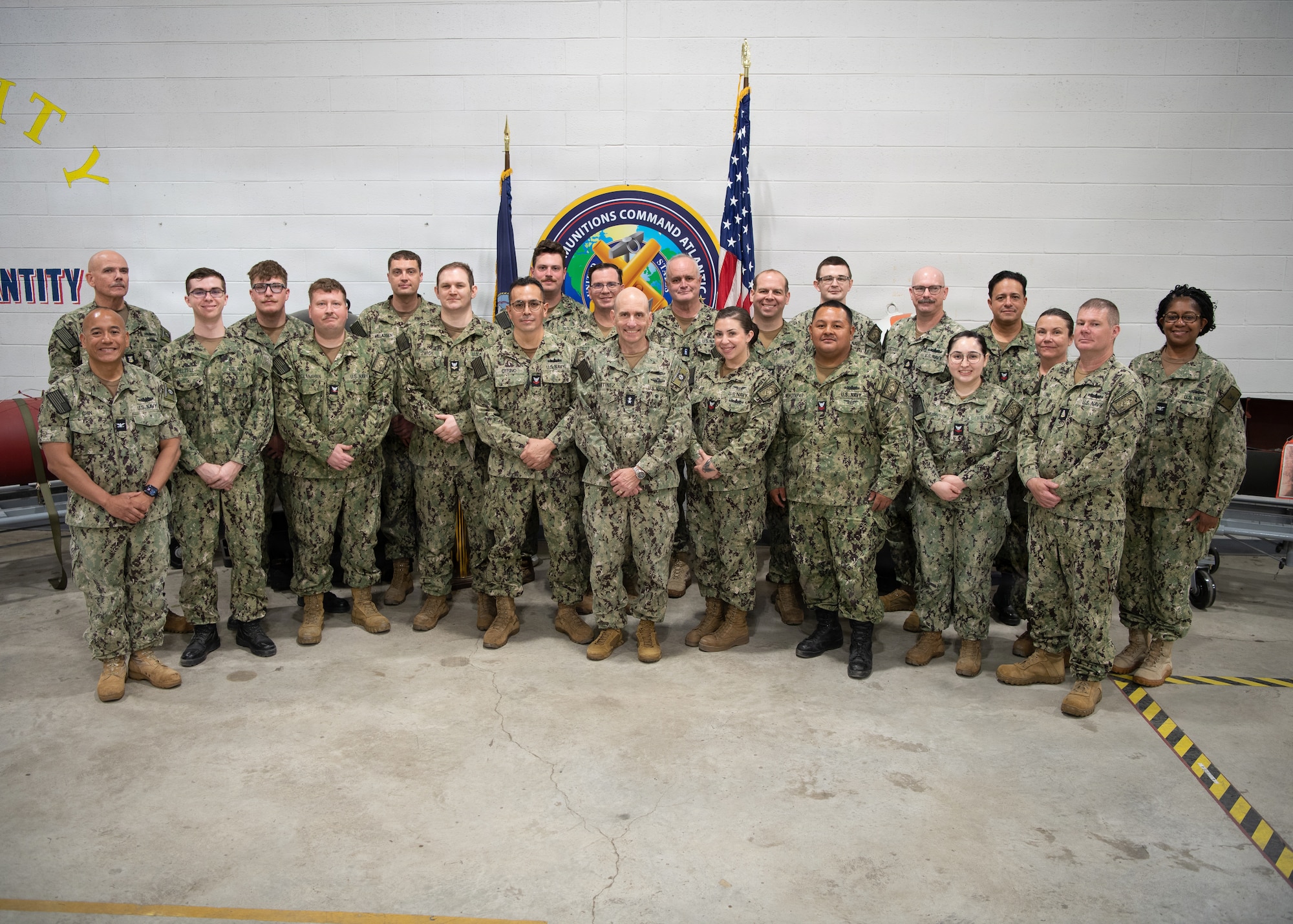 U.S. Navy Rear Adm. Joaquin Martinez de Pinillos, vice commander, U.S. Pacific Fleet, center, poses for a photo with Sailors assigned to Navy Reserve, Navy Munitions Command Pacific, Mine Assembly Unit Guam, following a visit to Naval Munitions Command Atlantic (NMCLANT) at Naval Weapons Station Charleston, May 6, 2026. The high-intensity training evolution was designed to evaluate personnel on their ability to safely, accurately, and rapidly assemble complex mine systems under simulated combat conditions. (U.S. Navy photo by Mass Communication Specialist 1st Class Matt Wright)