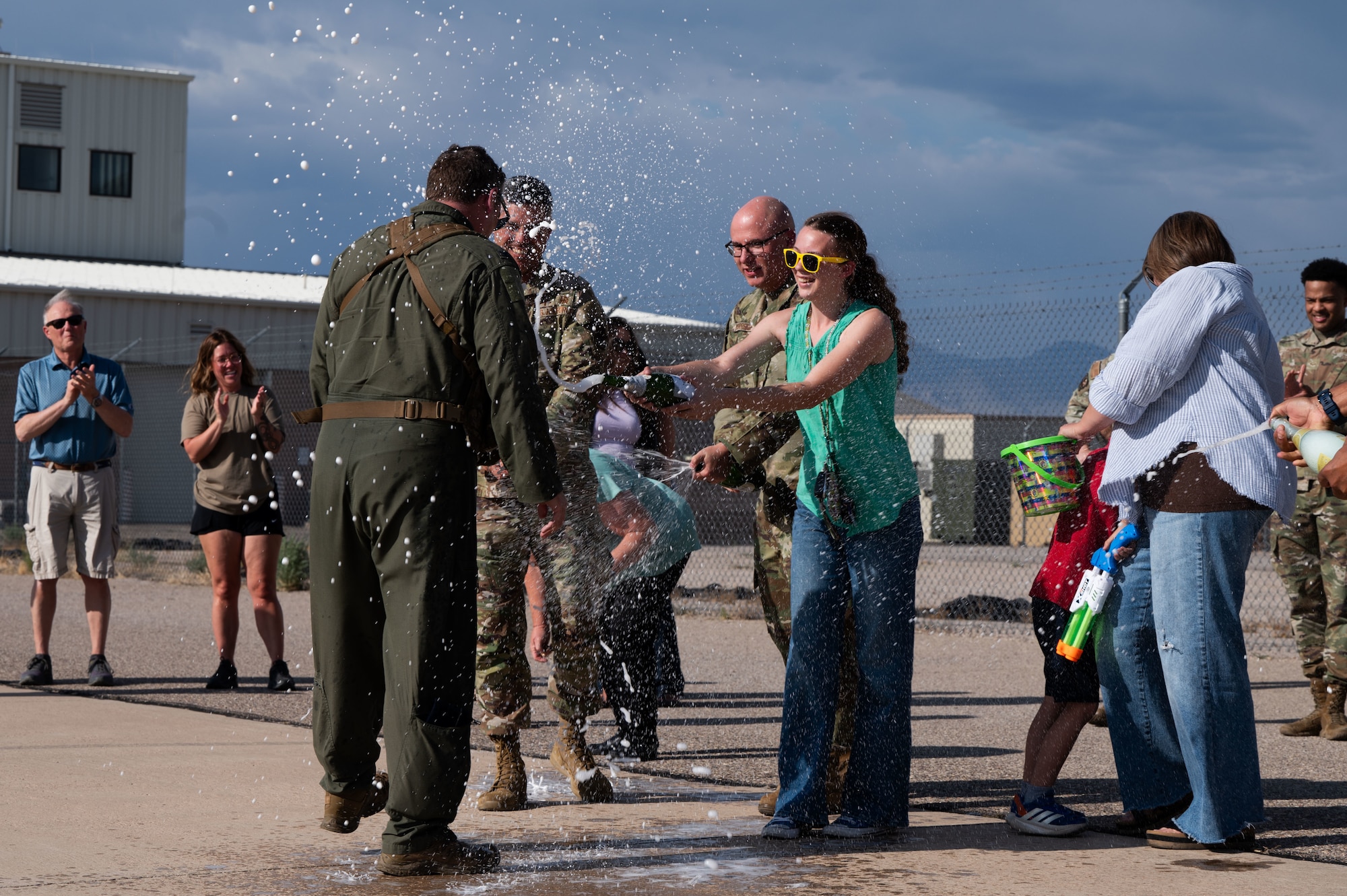 U.S. Air Force Col. Charles Redmond, 355th Wing deputy commander, is doused with water and champagne upon the completion of his “fini” flight” at Davis-Monthan Air Force Base, Arizona, May 12, 2026. Fini flights recognize the achievements and lasting impact of aviators throughout their career. (U.S. Air Force photo by Airman Najzee Kuzu)