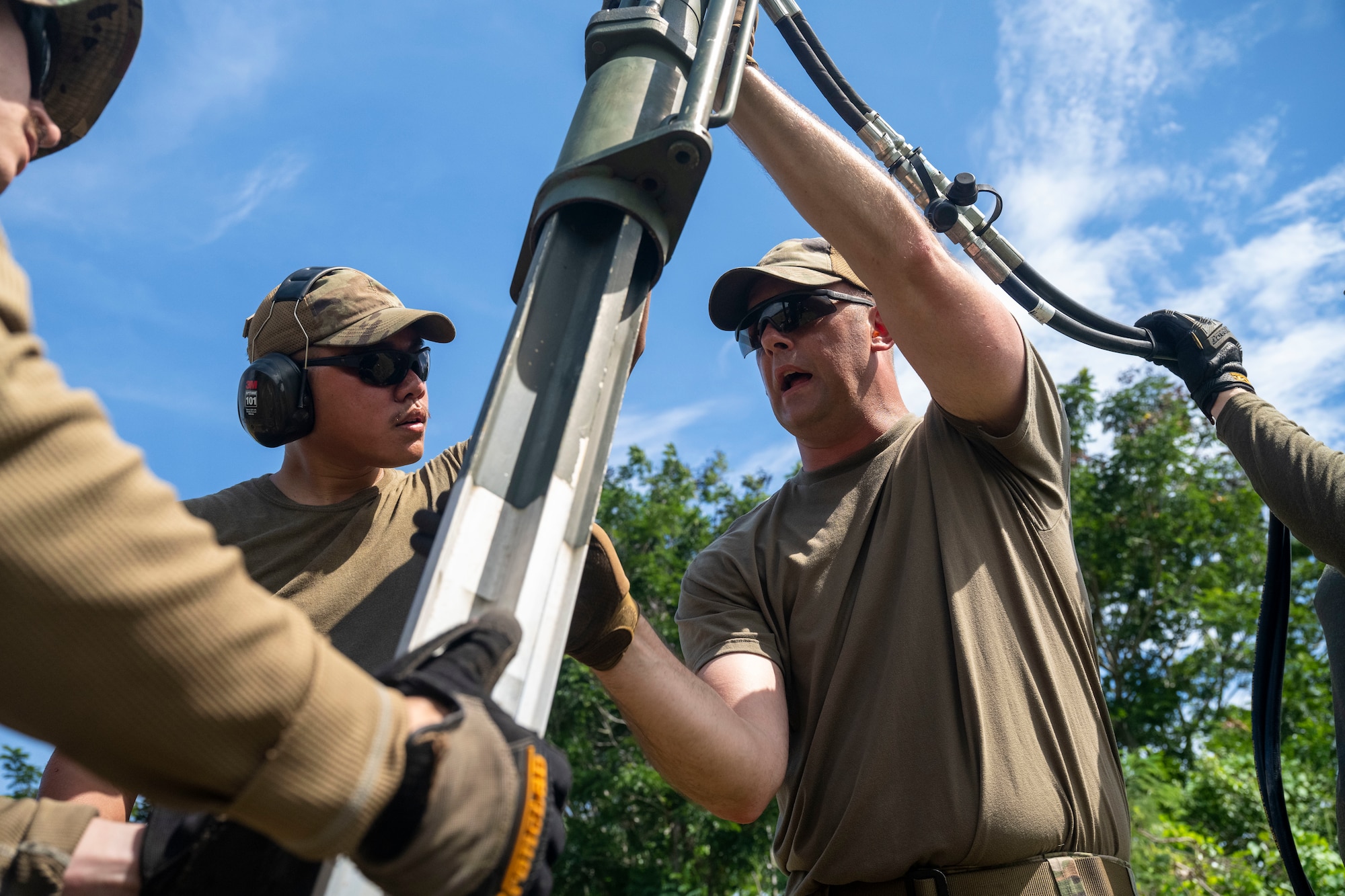 airmen use power tools