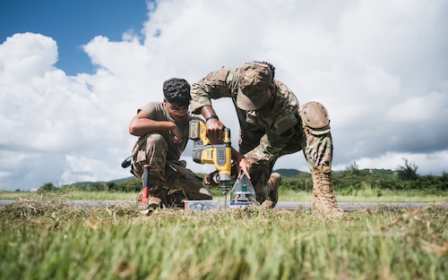 airmen use power tools