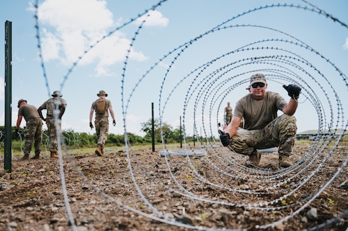 airmen use power tools