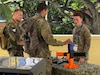 Specialist Isaiah Walter of the 25th Infantry Division’s Lightning Labs, speaks with German soldiers at the 2026 AUSA LANPAC Symposium in Honolulu, Hawaii, May 12, 2026