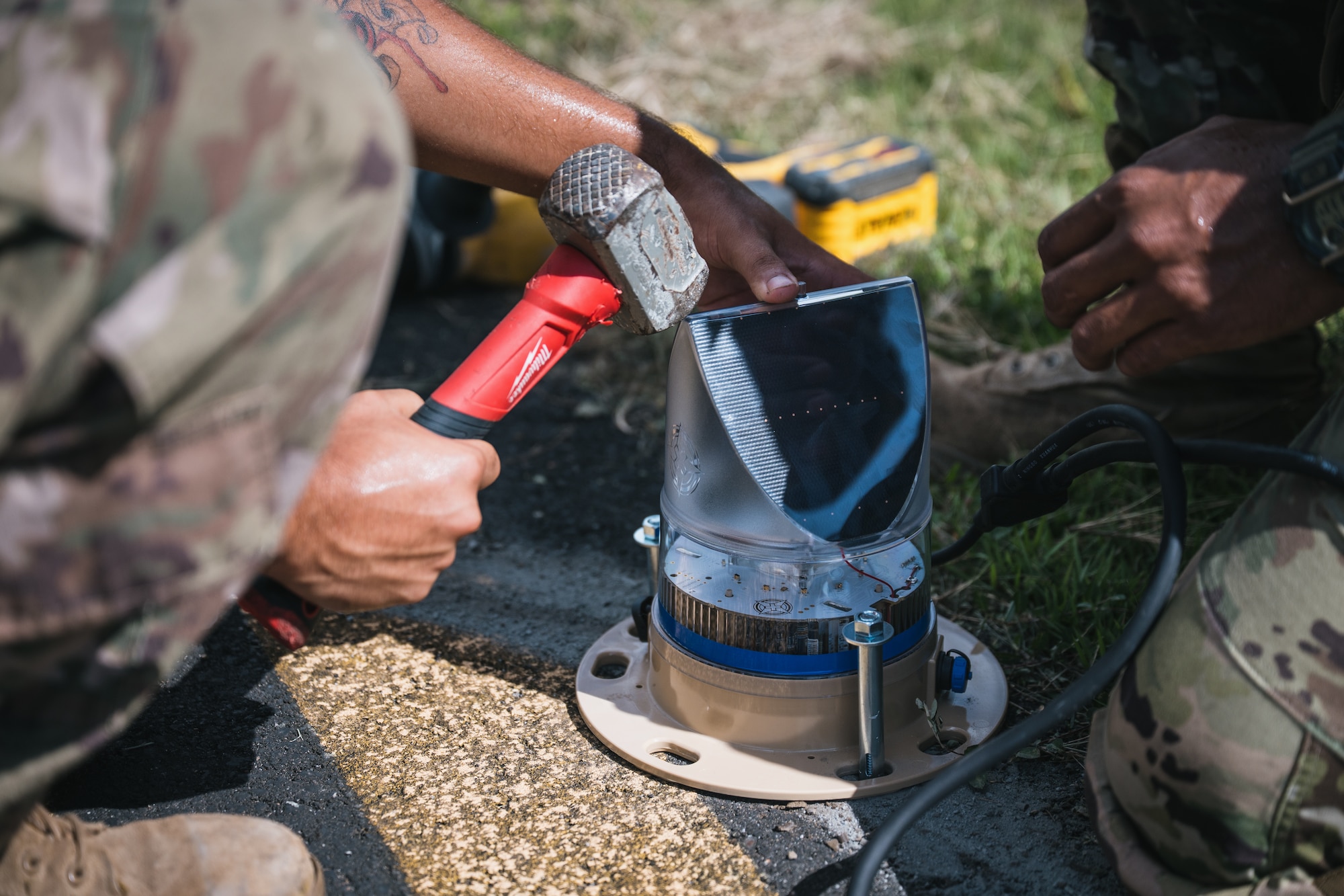 airmen use power tools