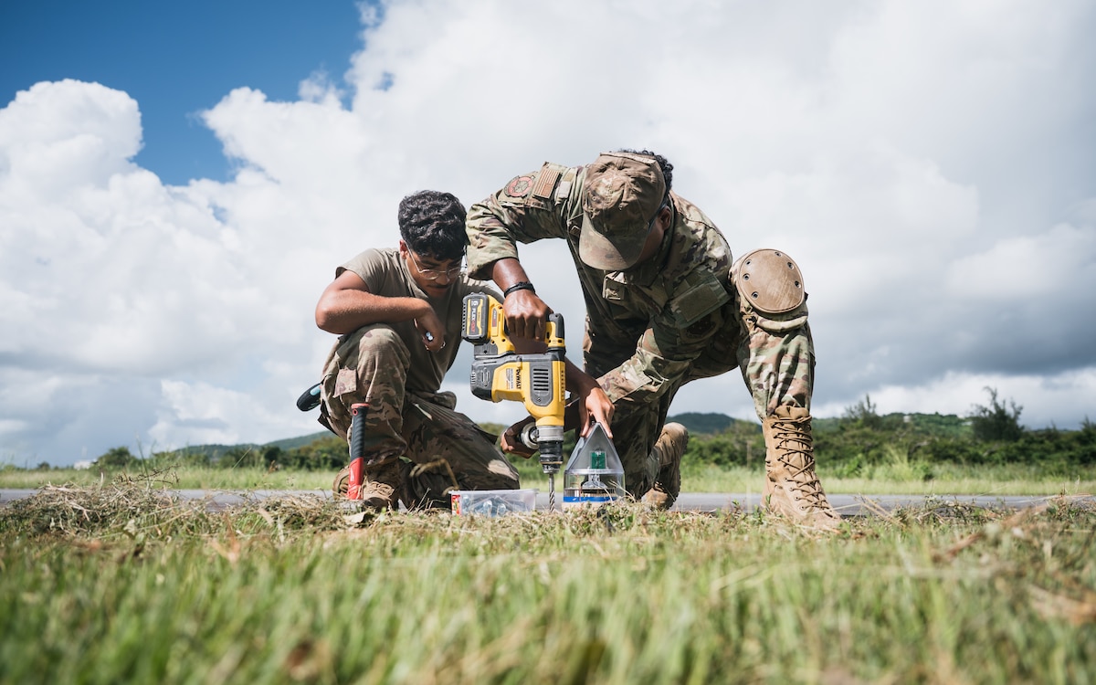 airmen use power tools
