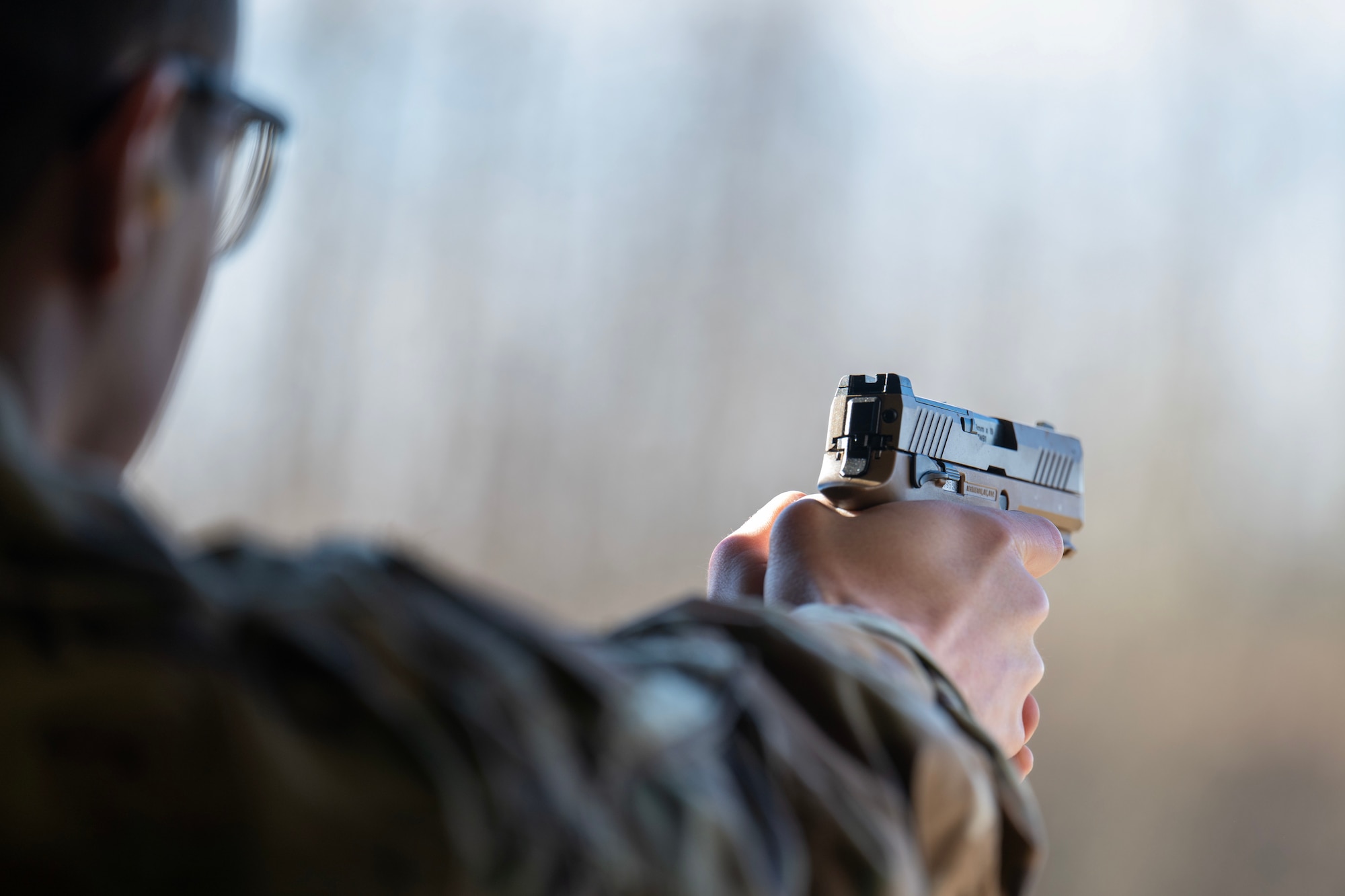 U.S. Air Force Tech. Sgt. Brian Austin, 354th Contracting Squadron contracting officer, prepares to shoot an M18 pistol during the Excellence in Competition event at Eielson Air Force Base, Alaska, May 13, 2026.