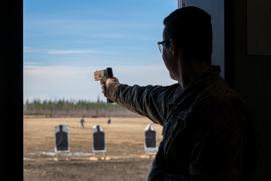U.S. Air Force 2nd Lt. Jack Flynn, 354th Civil Engineer Squadron requirements and optimization officer in charge, prepares to shoot an M18 pistol during the Excellence in Competition event at Eielson Air Force Base, Alaska, May 13, 2026.