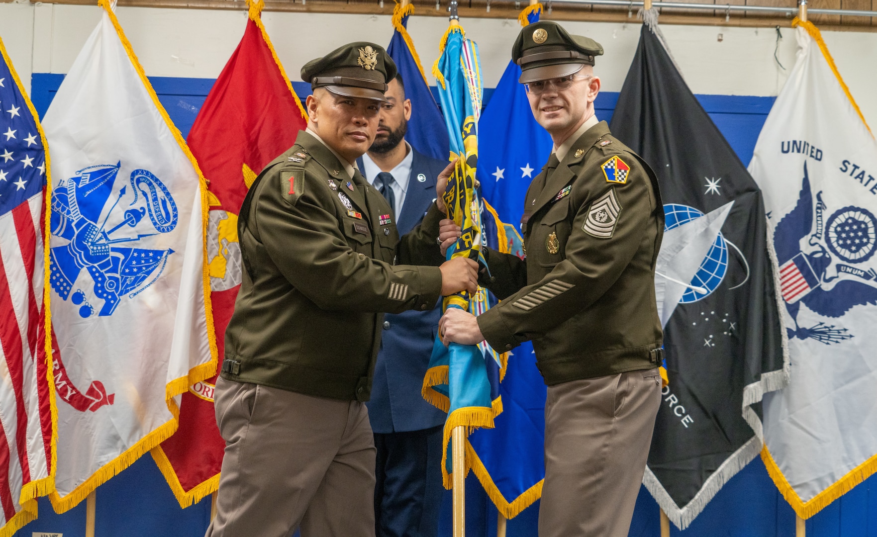 USMEPCOM Commander passes the unit guidon to Army Command Sgt. Maj. Gary Krese during a change of responsibility and retirement ceremony May 15. Krese accepted responsibility as the new senior enlisted advisor of USMEPCOM HQ, succeeding Army Command Sgt. Maj. Yveline Symonette.