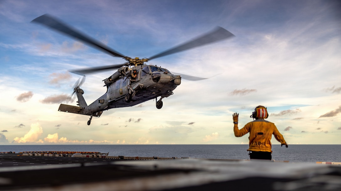 A U.S. Navy MH-60S Sea Hawk, assigned Helicopter Sea Combat Squadron (HSC) 21, hovers in preparation for fast-rope training aboard Wasp-class amphibious assault ship USS Boxer (LHD 4) in the Indian Ocean, May 4, 2026. The 11th Marine Expeditionary Unit, embarked aboard the Boxer Amphibious Ready Group, is a persistent, combat credible force contributing to deterrence and crisis response in the U.S. 7th Fleet area of operations. U.S. 7th Fleet, the U.S. Navy's largest forward-deployed numbered fleet, routinely interacts and operates with allies and partners to preserve a free and open Indo-Pacific. (U.S. Marine Corps photo by Sgt. Trent A. Henry)