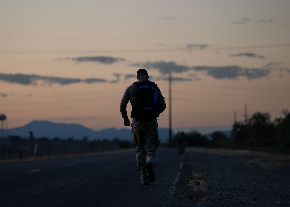 An Airman participates in the Norwegian Foot March held at Davis-Monthan Air Force Base, Ariz., May 2, 2026. Participants completed an 18.6-mile course while wearing a combat uniform and carrying a 25-pound rucksack within 4 hours and 30 minutes for men and 4 hours and 50 minutes for women. (U.S. Air Force photo by Airman Najzee Kuzu)