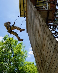 A Soldier competing in the Region V Best Warrior Competition rappels from a training tower at Camp Beauregard in Pineville, Louisiana, May 4, 2026.