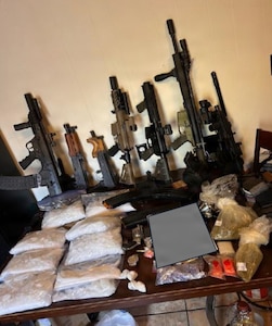 Illicit drugs and weapons sit on display after seizure by the Georgia Bureau of Investigation and the Butts County Sheriff’s Office in March 2026.