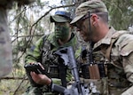 A Swedish Armed Forces service member, left, speaks with a New York Army National Guard Soldier with Troop C, 2nd Squadron, 101st Cavalry Regiment, during exercise Northern Lights 26, April 28, 2026, in Habo-Tibble, Sweden. Northern Lights 26, also known as Aurora 26 in Sweden, is a multinational exercise involving 18,000 soldiers from 13 countries aimed at strengthening defense capabilities and enhancing interoperability with international allies. Photo by Master Sgt. Warren W. Wright Jr.