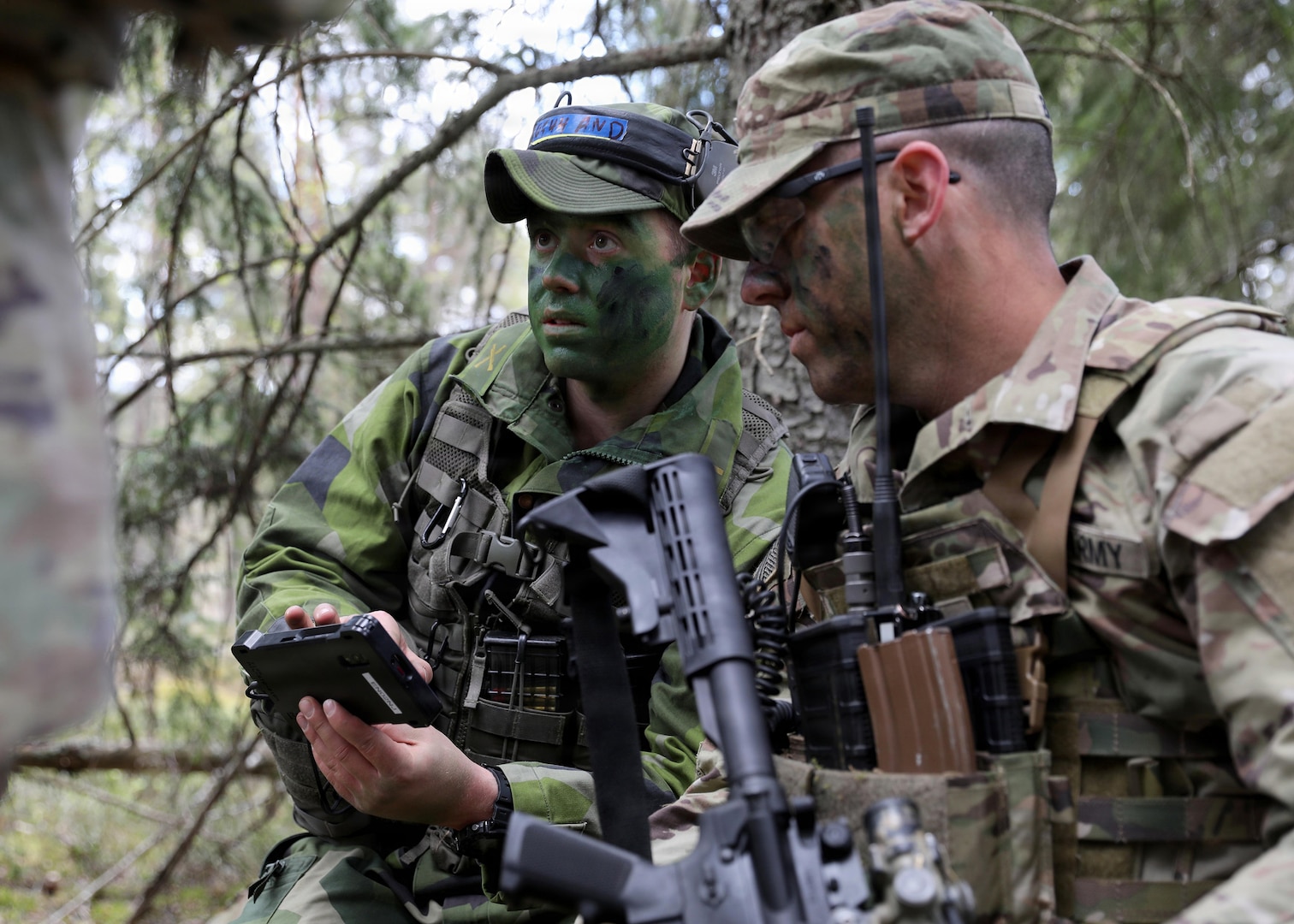 A Swedish Armed Forces service member, left, speaks with a New York Army National Guard Soldier with Troop C, 2nd Squadron, 101st Cavalry Regiment, during exercise Northern Lights 26, April 28, 2026, in Habo-Tibble, Sweden.