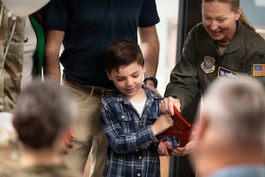 Cillian Crawford, son of Courtney and retired U.S. Air Force Maj. Brendan Crawford, and U.S. Air Force Col. Kathleen Hasson, 305th Air Mobility Wing commander, cut the ribbon to open Courtney’s Cove at Joint Base McGuire-Dix-Lakehurst, N.J., April 2, 2026.