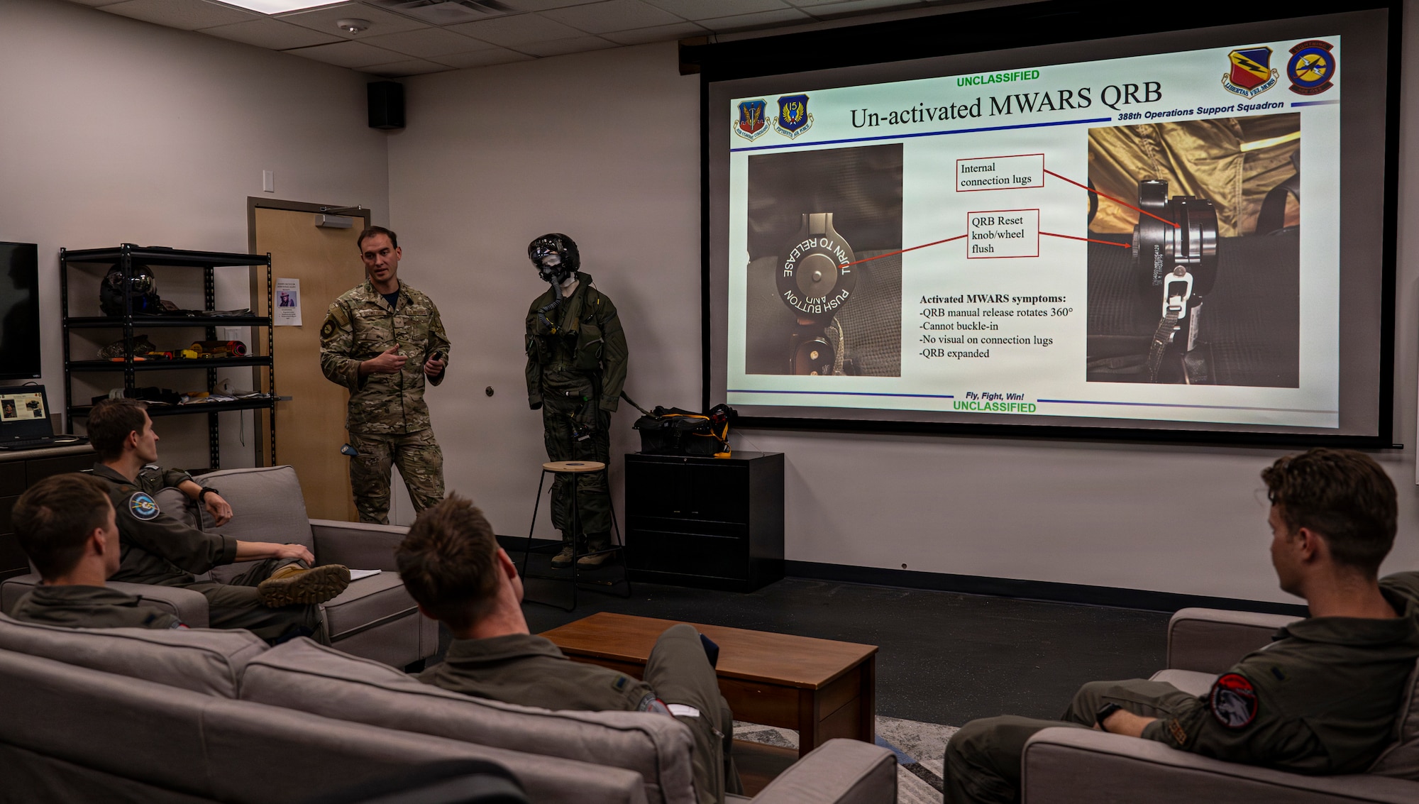 A photo of an Airman briefing slides in a classroom setting