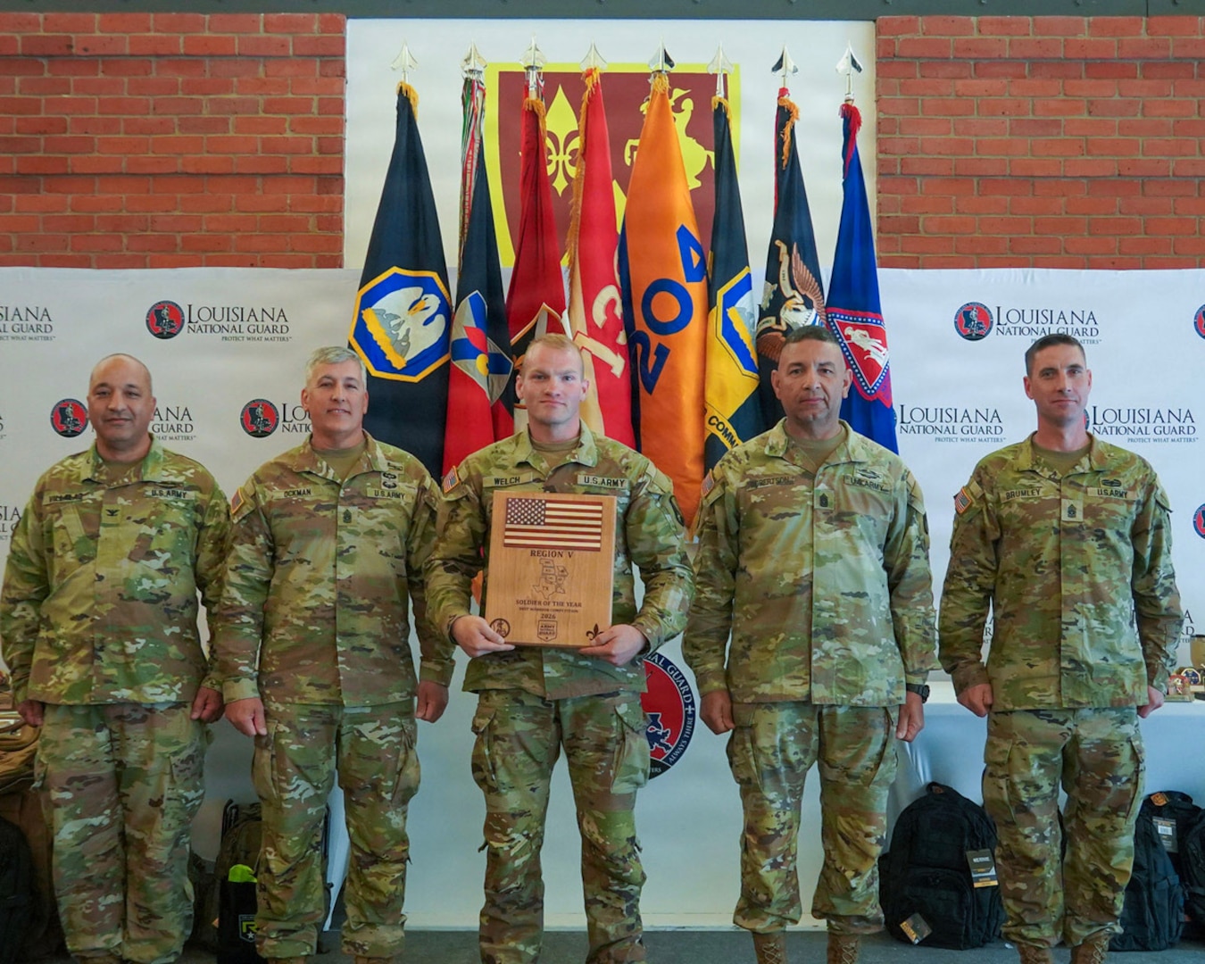 Spc. Christian Welch, assigned to Headquarters and Headquarters Company, 205th Engineer Battalion, 225th Engineer Brigade, Louisiana Army National Guard, poses with senior Louisiana National Guard leaders after being named Region V Soldier of the Year during the Region V Best Warrior Competition awards ceremony at Jackson Barracks in New Orleans, Louisiana, May 7, 2026.