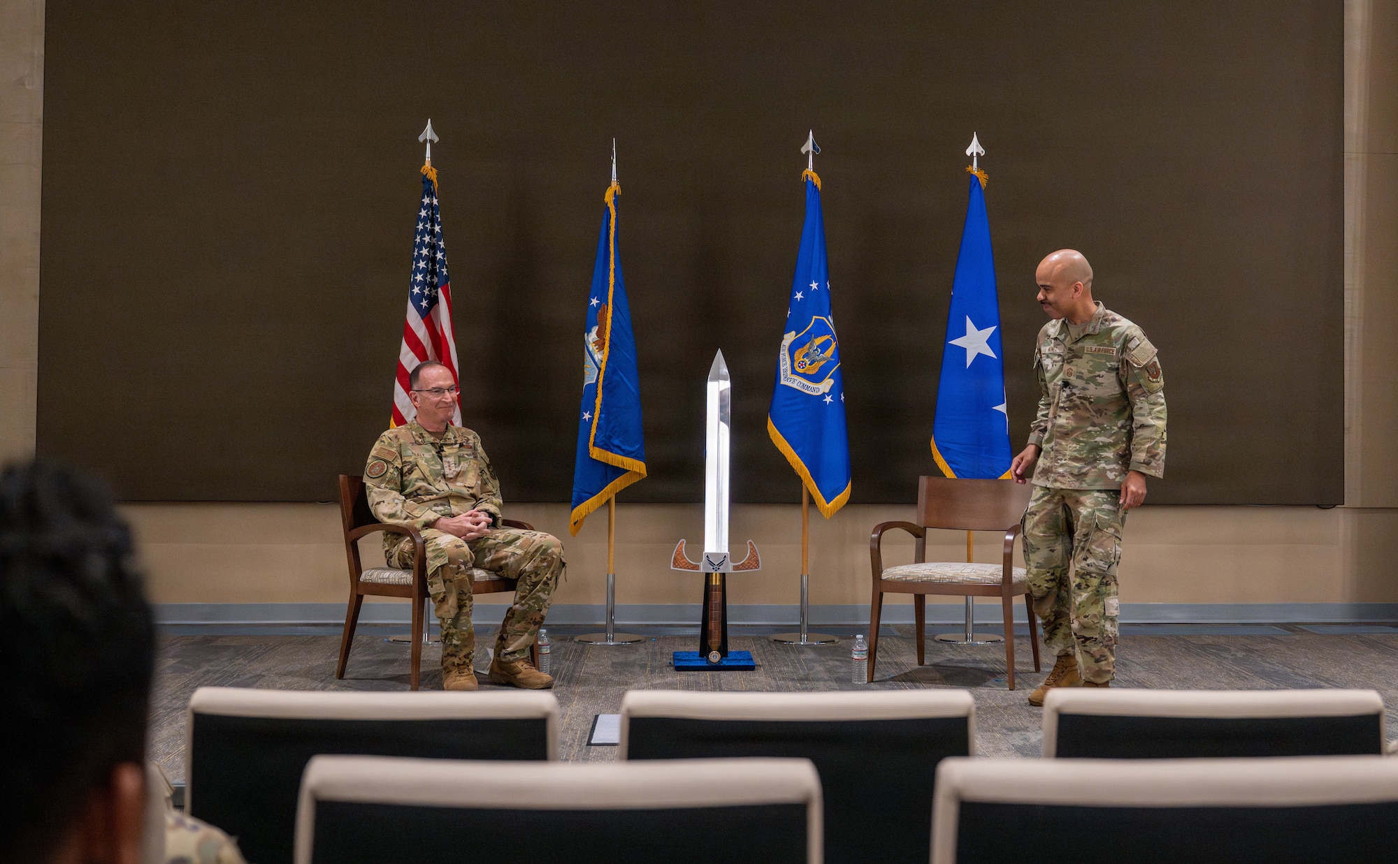 Two Airmen standing on stage