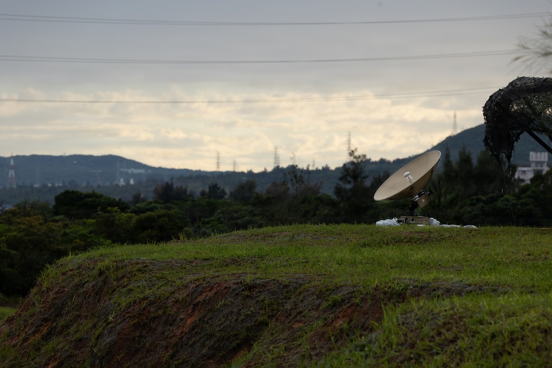 A U.S. Marine Corps wideband satellite-expeditionary assigned to 7th Communication Battalion, III Marine Expeditionary Force Information Group, operates atop a hill during Kaiju Rain 26 at Camp Hansen, Okinawa, Japan, May 6, 2026. Kaiju Rain 26 is a III MIG-led exercise, focused on integrating multi-domain information capabilities, strengthening the U.S.-Japan Alliance, and supporting regional stability in the Indo-Pacific. (U.S. Marine Corps photo by Sgt. Ramon Cardoza)