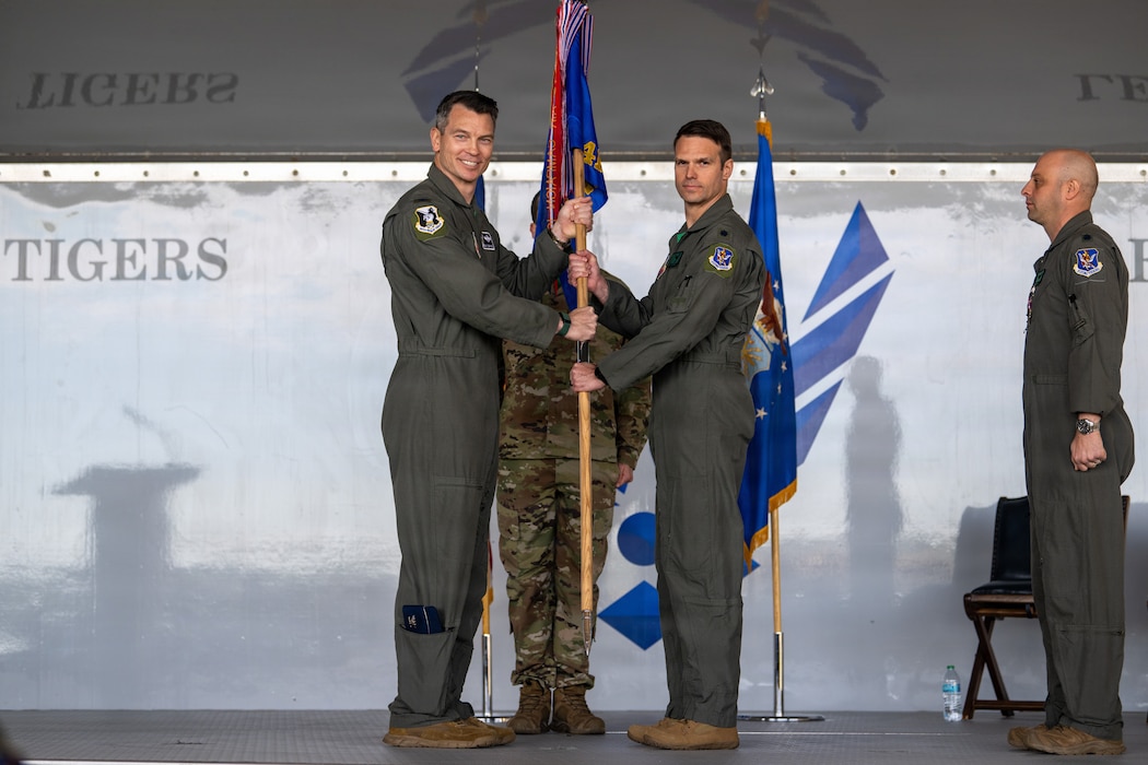 U.S. Air Force Col. Brian Desautels, 347th Rescue Group commander, left, passes the guidon to Lt. Col. Matthew Pfarr, 41st Rescue Squadron incoming commander, at Moody Air Force Base, Georgia, May 15, 2026. Pfarr recently served as the 41st RQS director of operations. The passing of the guidon represents the official change of leadership within a unit. (U.S. Air Force photo by Senior Airman Iain Stanley)