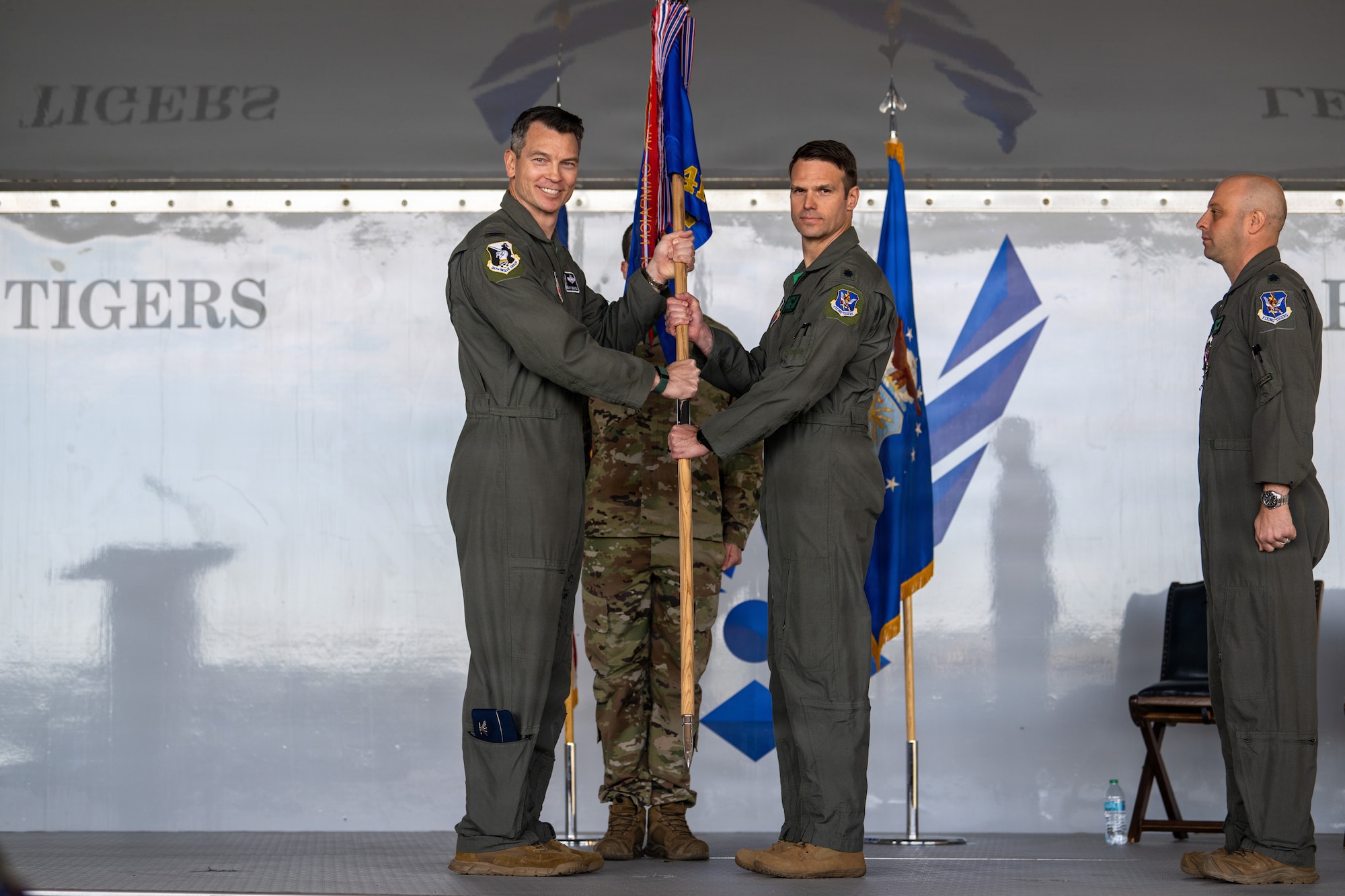 U.S. Air Force Col. Brian Desautels, 347th Rescue Group commander, left, passes the guidon to Lt. Col. Matthew Pfarr, 41st Rescue Squadron incoming commander, at Moody Air Force Base, Georgia, May 15, 2026. Pfarr recently served as the 41st RQS director of operations. The passing of the guidon represents the official change of leadership within a unit. (U.S. Air Force photo by Senior Airman Iain Stanley)