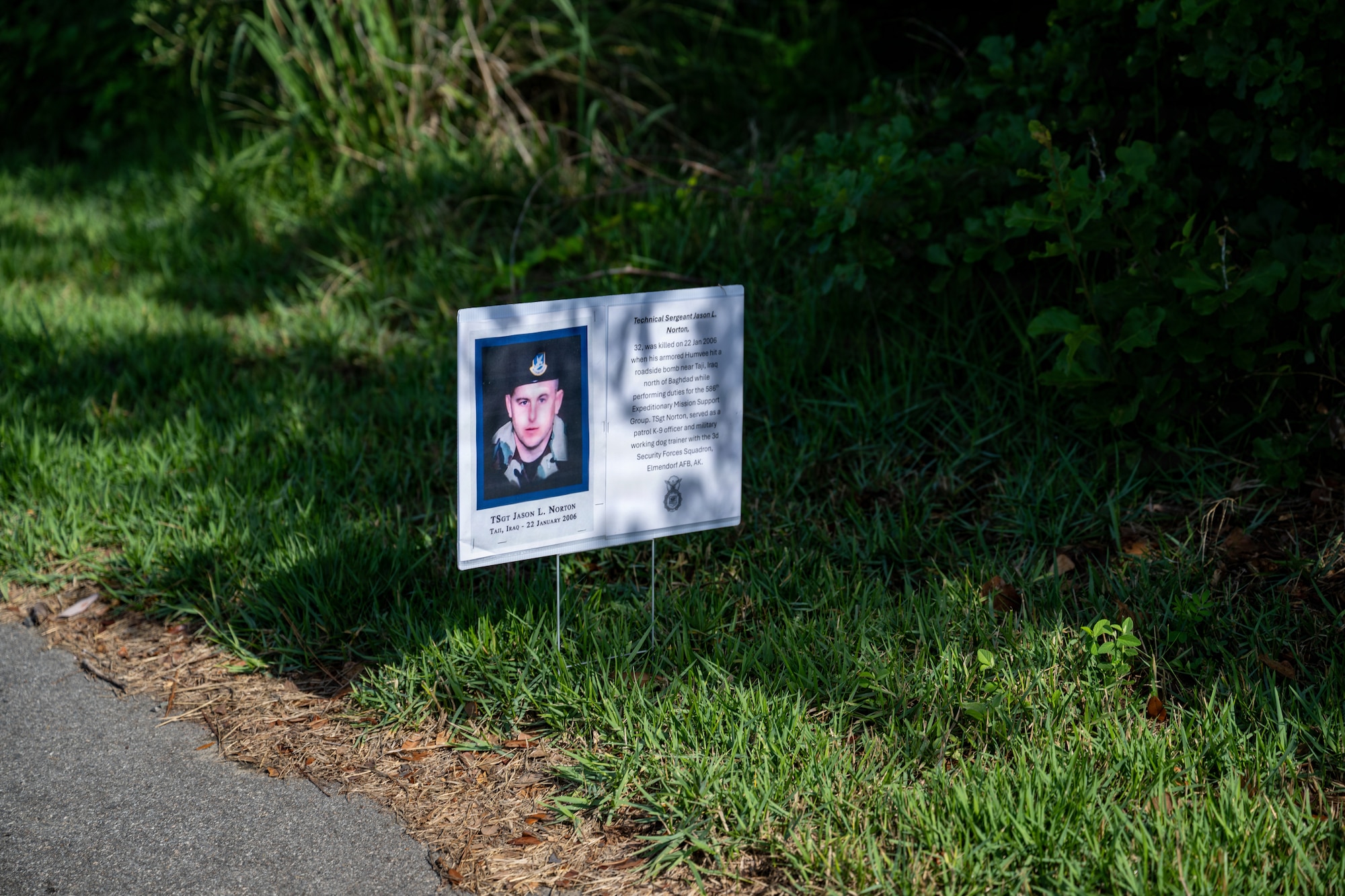 A photo of a fallen law enforcement officer is displayed along the route of a memorial ruck march at Moody Air Force Base, Georgia, May 11, 2026. Images of officers who died in the line of duty were placed throughout the route in observance of National Police Week to honor their service and sacrifice. (U.S. Air Force photo by Airman 1st Class Rachel Howell)