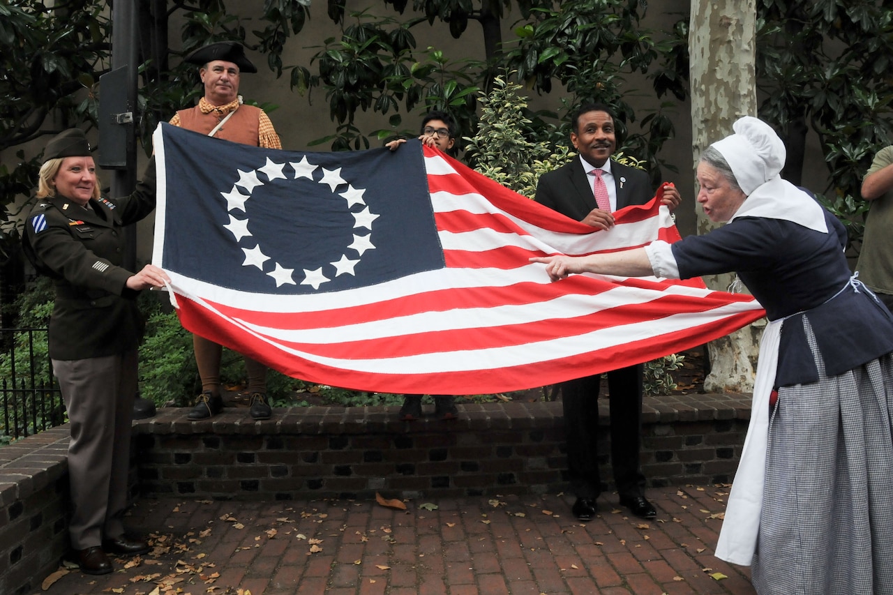 People display an old-style U.S. flag.