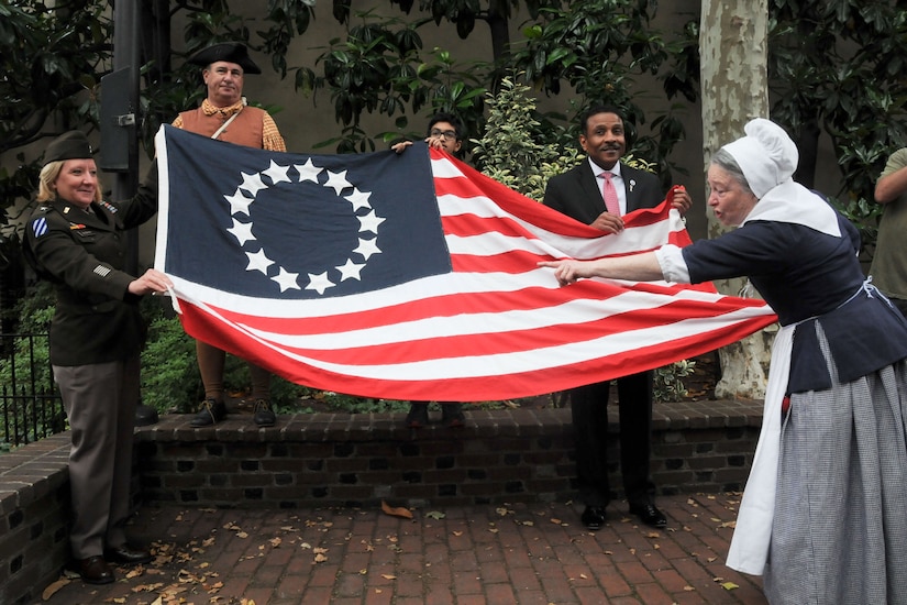 People display an old-style U.S. flag.