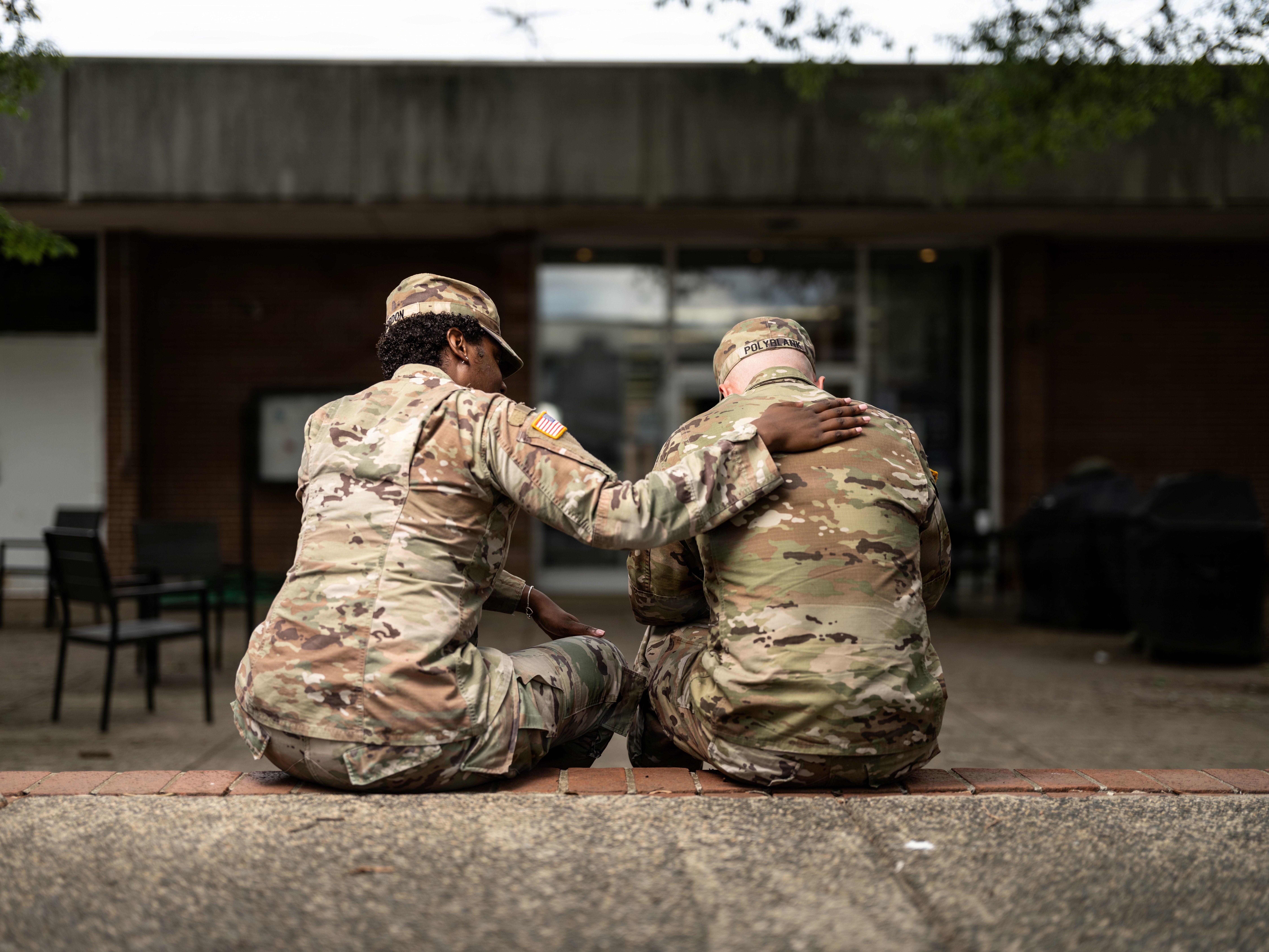 Two soldiers sitting side by side.
