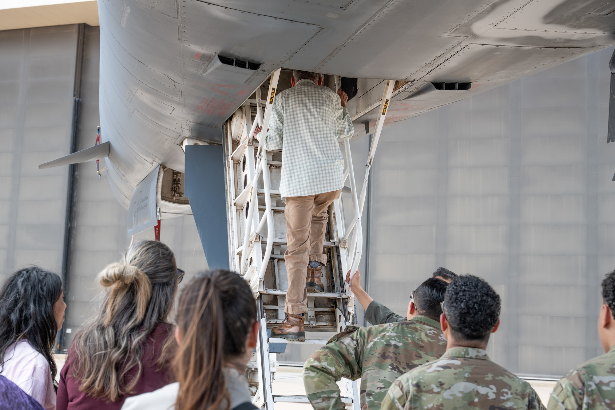 Abilene medical professionals and U.S. Air Force Airmen prepare to view a B-1B Lancer cockpit during a medical provider collaboration tour at Dyess Air Force Base, Texas, May 8, 2026. The 7th Medical Group hosted the event to connect local medical providers with military personnel, ensuring the civilian healthcare network understands the operational environment and readiness requirements of the Airmen they treat. (U.S. Air Force Photo by Airman 1st Class Caleb Schellenberg)