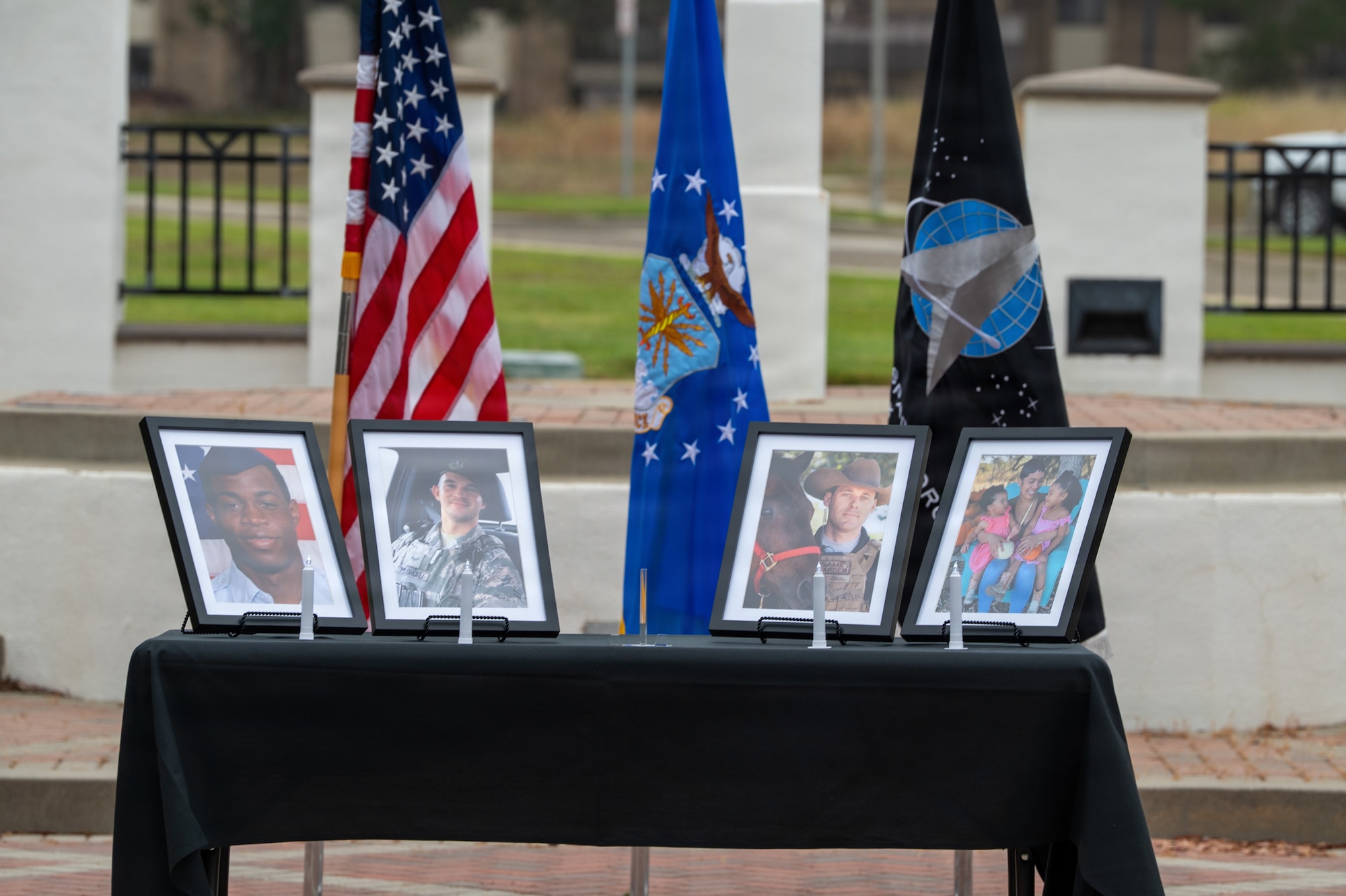Four framed photos on a table outside.