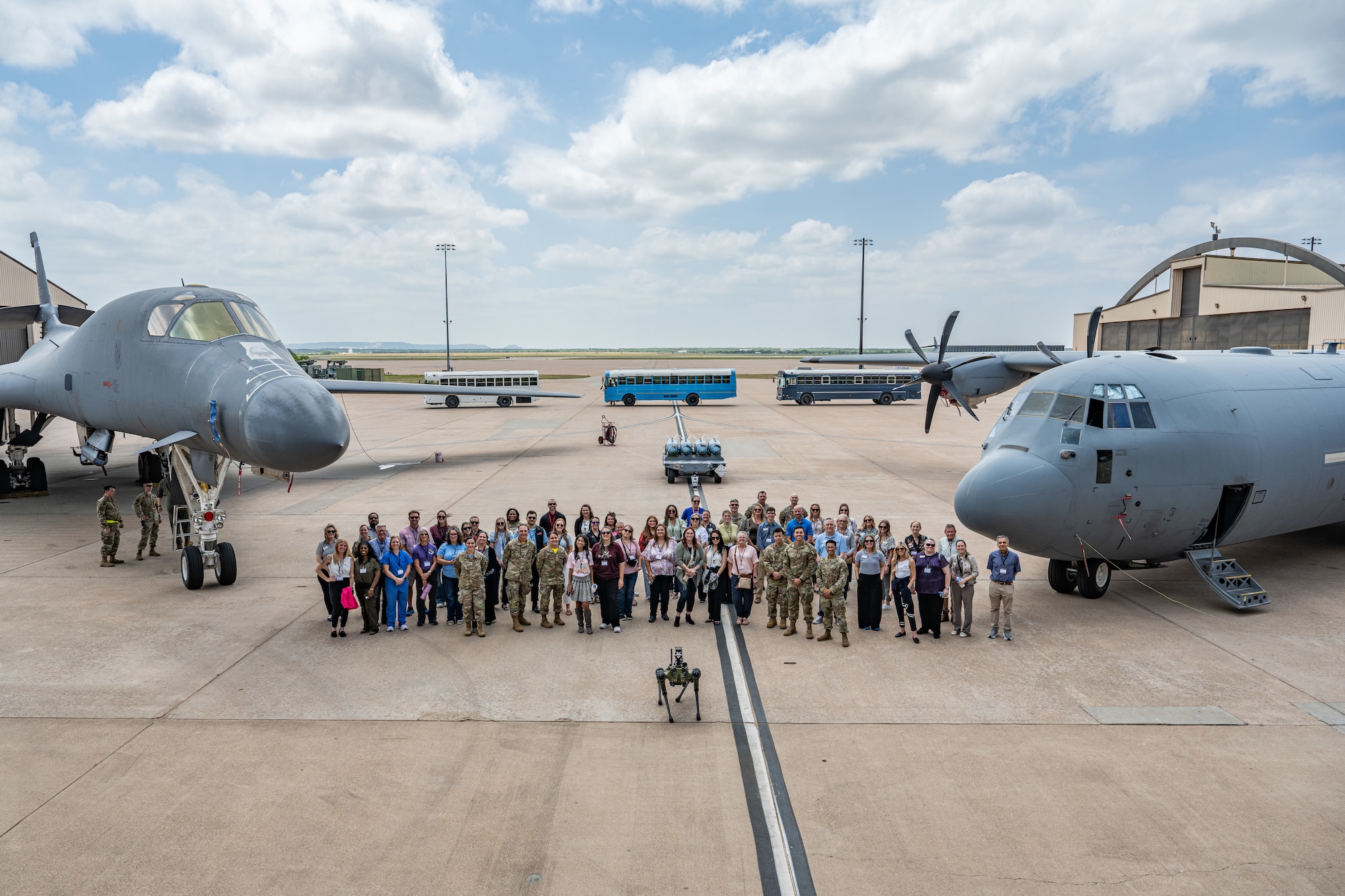 Abilene medical professionals and U.S. Airmen assigned to the 7th Medical Group pose for a group photo between a B-1B Lancer and a C-130J Super Hercules during a medical provider collaboration tour at Dyess Air Force Base, Texas, May 8, 2026. The tour enhanced partnerships between the 7th MDG and the local medical community, a network that provides essential off-base care to maintain the deployment readiness  of Team Dyess members and their families. (U.S. Air Force Photo by Airman 1st Class Caleb Schellenberg)