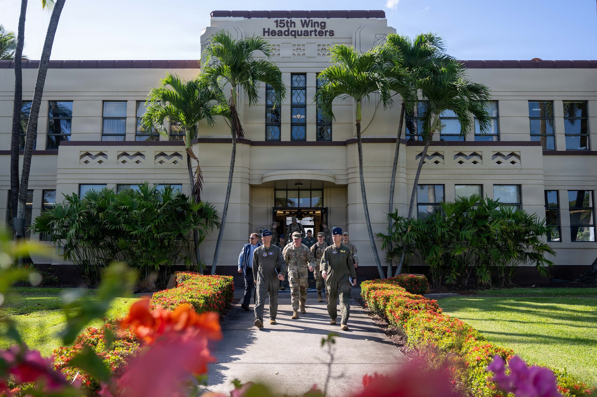 U.S. Air Force Col. Garrett Fisher (right), 15th Wing commander, Air Force Chief of Staff Gen. Ken Wilsbach (left) and Chief Master Sergeant of the Air Force David Wolfe (middle) leave the 15th Wing Headquarters building to tour Joint Base Pearl Harbor-Hickam.