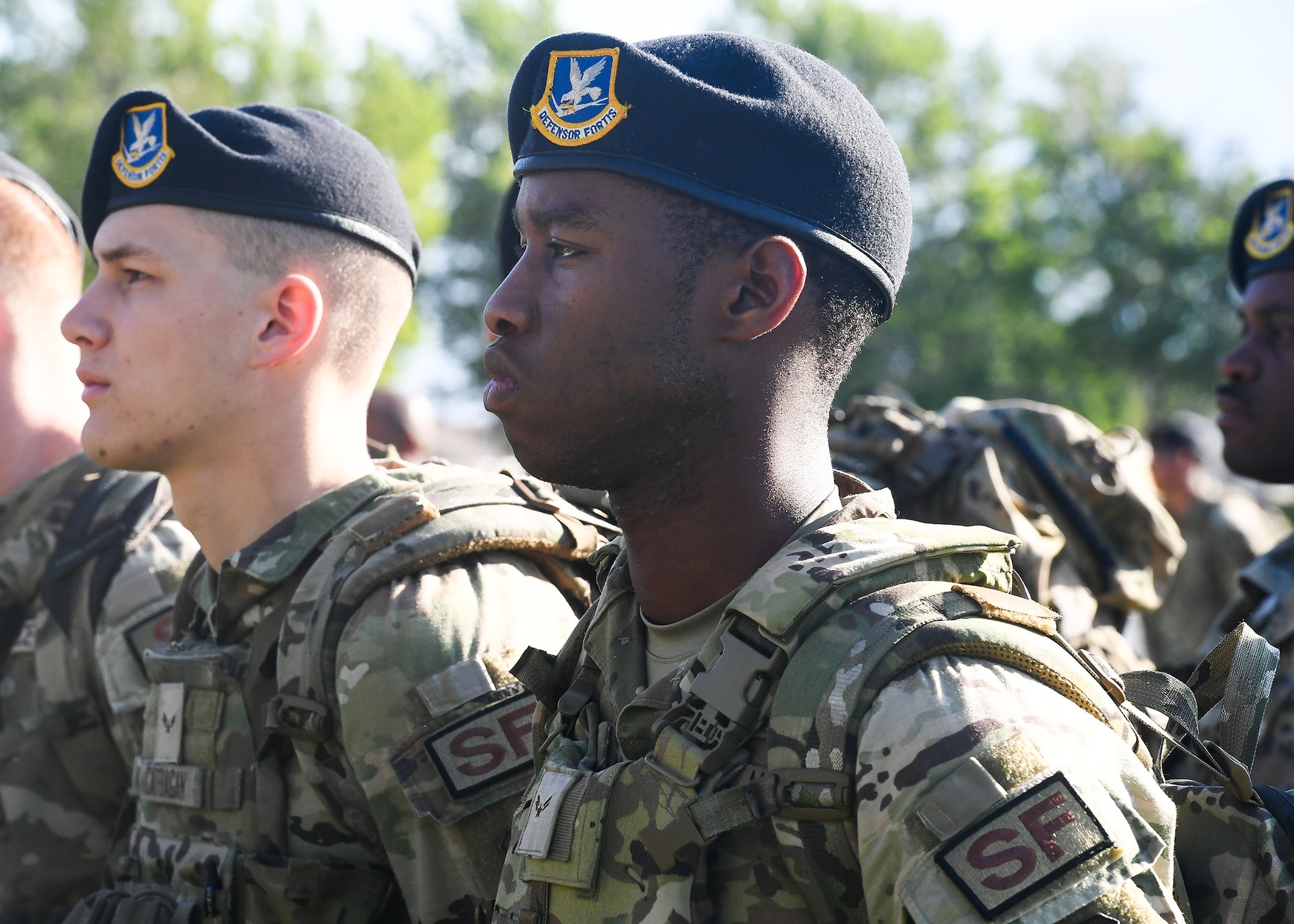 A1C Andrew Michaud from the 377th WSSS listens as SFG Commander Col. Matthew Foisy gives opening remarks for Police Week at Hardin Field, Kirtland AFB. (U.S. Air Force photo by Todd Berenger)