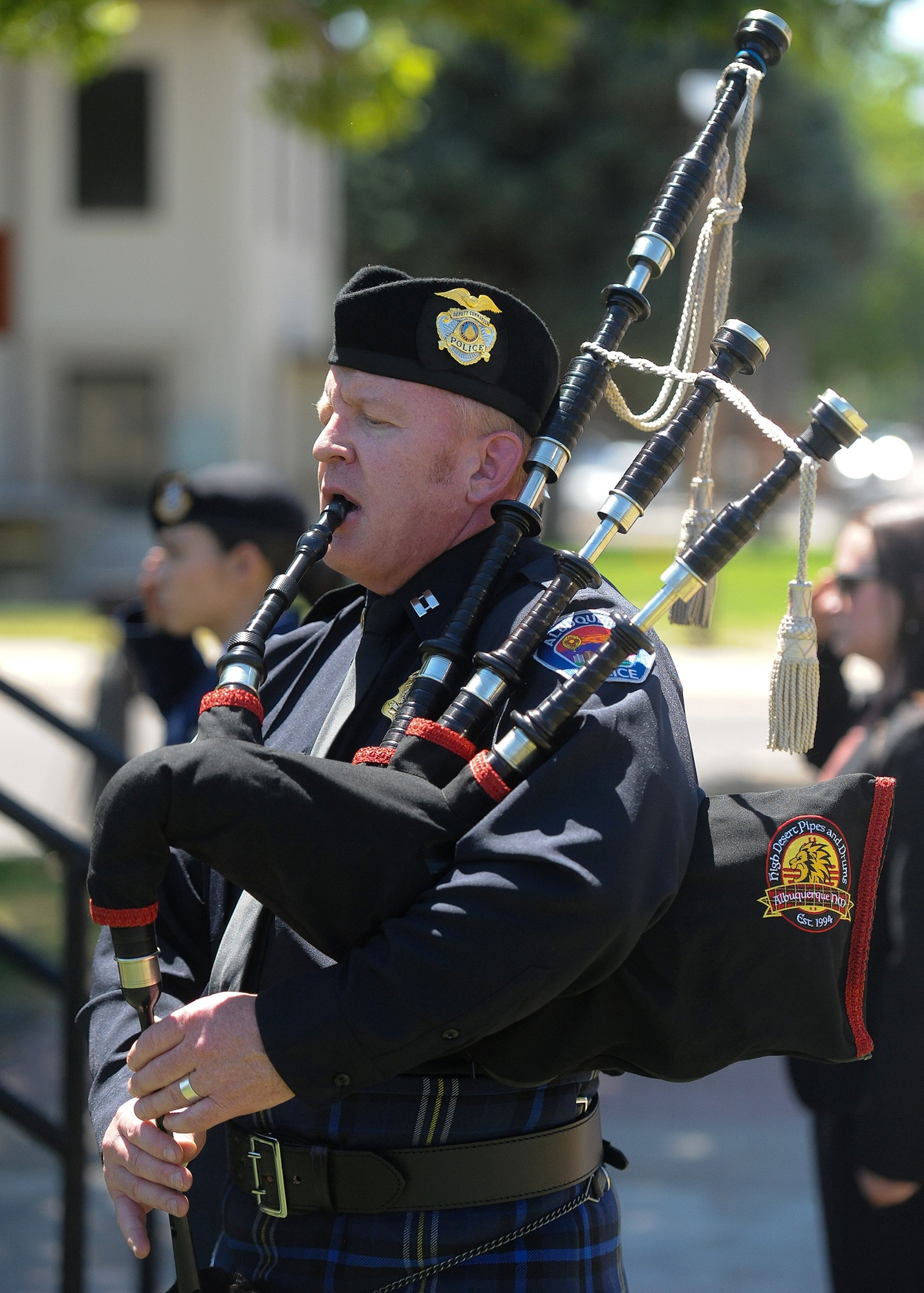 Matt McElroy from the APD Honor Guard performs “Taps” and “Amazing Grace” during the closing moments of Police Week. 
(U.S. Air Force photo by Todd Berenger)
