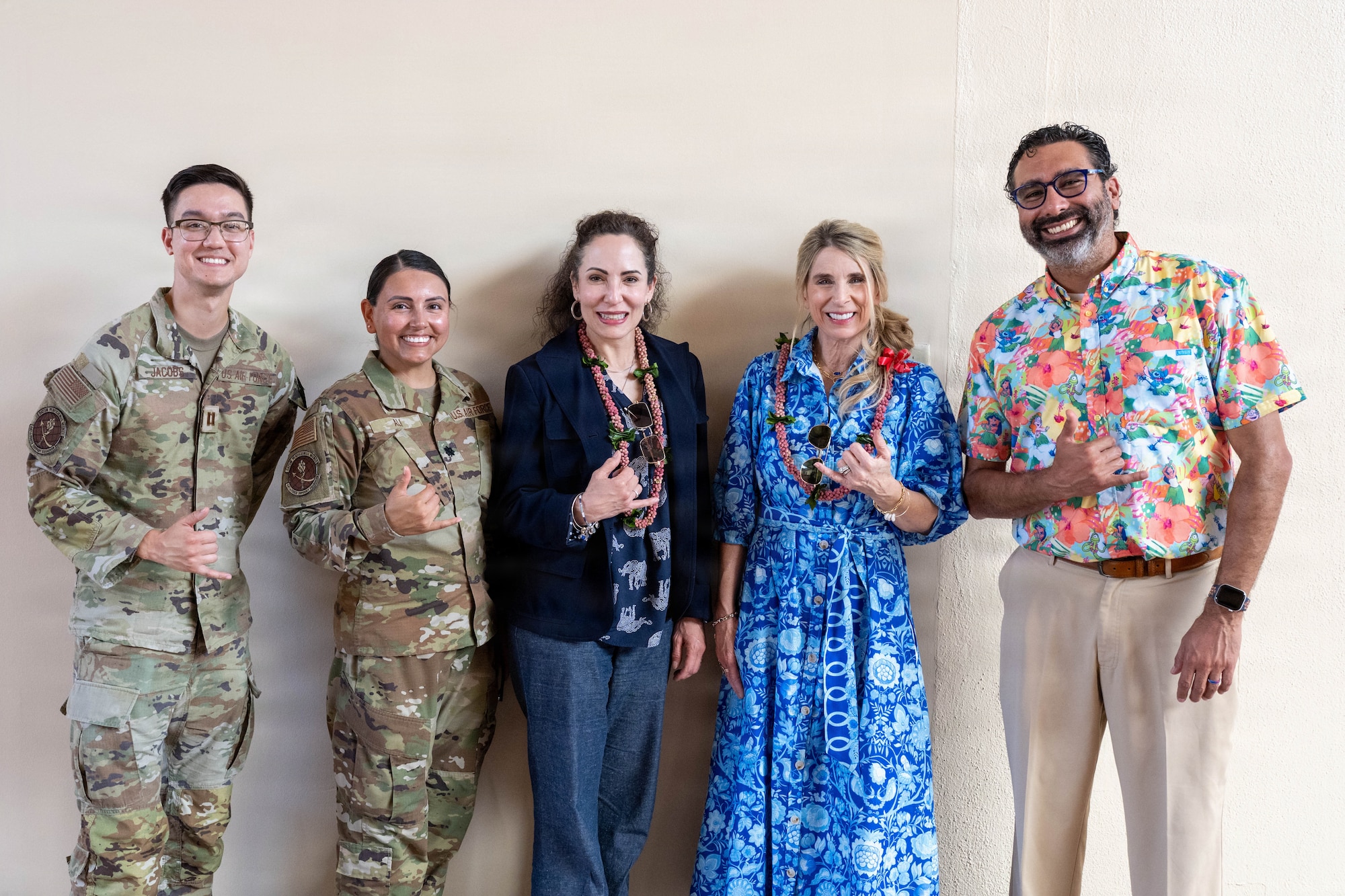 Group photo of 5 people giving a shaka hand sign.