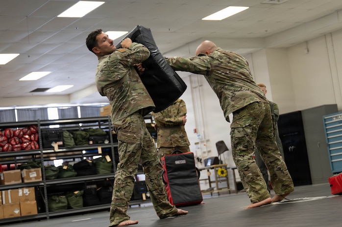 U.S. Air Force Tech. Sgt. Jonah Caliri and Tech. Sgt. Ahron Rasabi, 15th Operational Support Squadron Survival, Evasion, Resistance and Escape (SERE) specialists, demonstrate proper hand-to-hand combat techniques at Joint Base Pearl Harbor-Hickam, May 13, 2026. Students learned basic SERE combative techniques including boxing, Muay Thai and grappling. (U.S. Air Force photo by Senior Airman Lauren Torres)