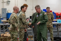 Adm. Samuel J. Paparo, commander of U.S. Indo-Pacific Command, coins Tech. Sgt. Ahron Rasabi, 15th Operational Support Squadron Survival, Evasion, Resistance and Escape (SERE) Specialist at Joint Base Pearl Harbor-Hickam, May 13, 2026. Rasabi assisted during a SERE instructional course, demonstrating hand-to-hand combat fundamentals and proper techniques. (U.S. Air Force photo by Senior Airman Lauren Torres)