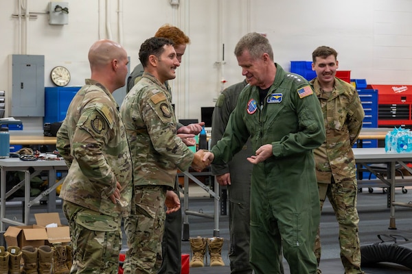 Adm. Samuel J. Paparo, commander of U.S. Indo-Pacific Command, coins Tech. Sgt. Ahron Rasabi, 15th Operational Support Squadron Survival, Evasion, Resistance and Escape (SERE) Specialist at Joint Base Pearl Harbor-Hickam, May 13, 2026. Rasabi assisted during a SERE instructional course, demonstrating hand-to-hand combat fundamentals and proper techniques. (U.S. Air Force photo by Senior Airman Lauren Torres)