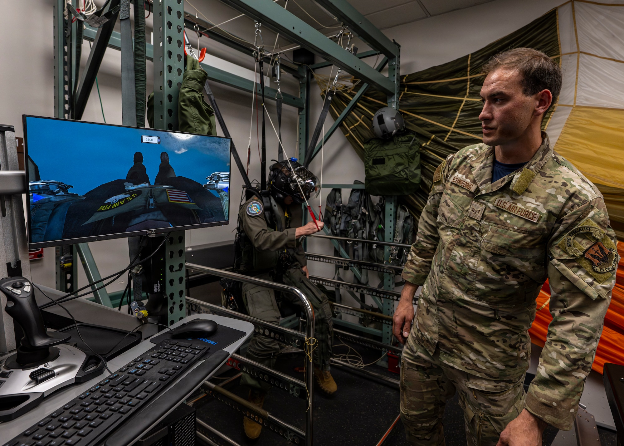 A photo of an Airman in front of a SERE training setup