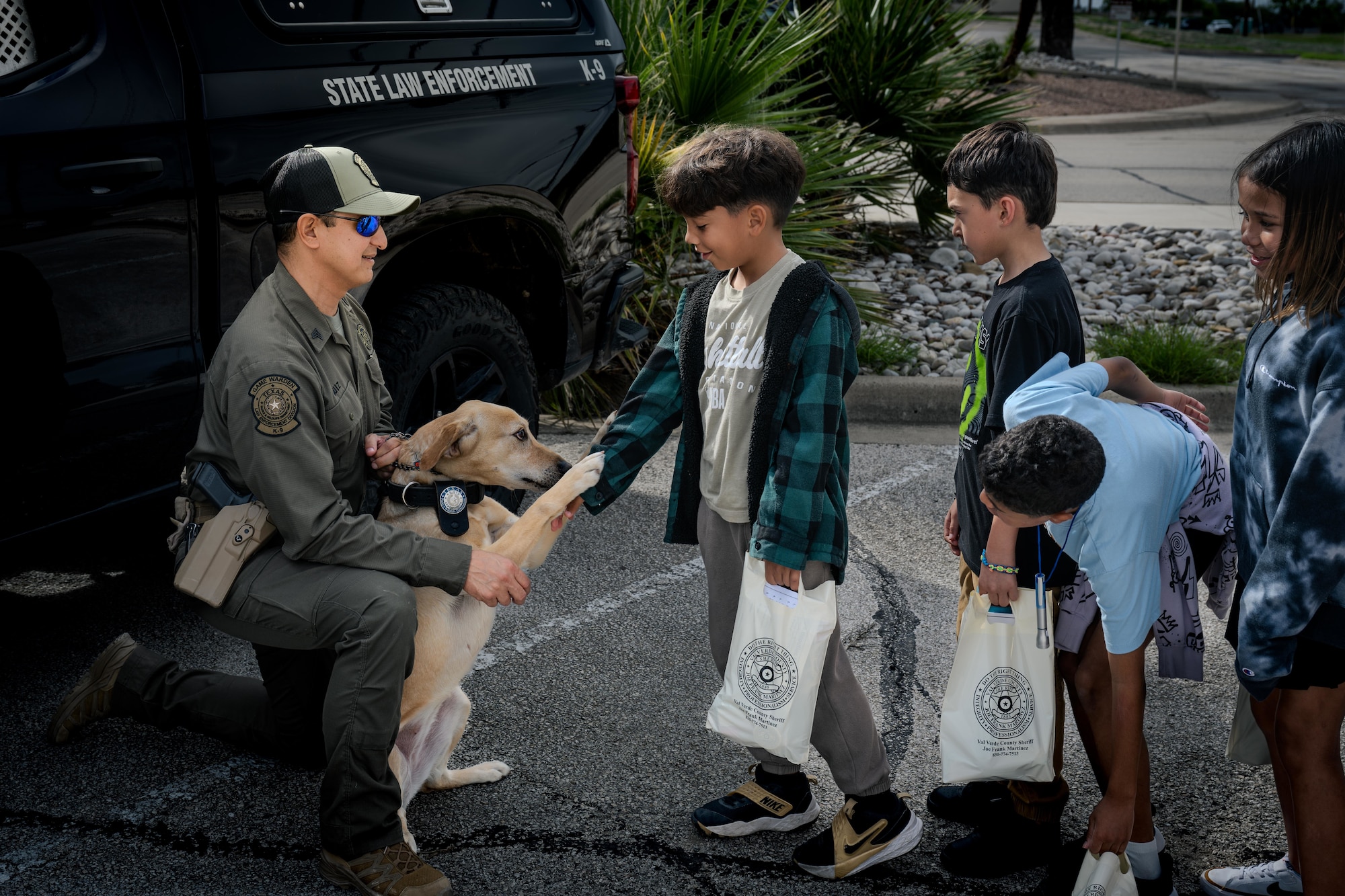 Texas Parks and Wildlife Department, game warden, introduces students to his K9 unit at Robert Bobby Barrera Elementary School, Texas, May 5, 2026. K9 units assist game wardens across Texas with search and rescue operations, wildlife detection, evidence recovery, and suspect tracking. (U.S. Air Force photo by Airman 1st Class Harrison Sullivan)