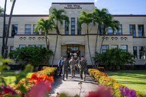 U.S. Air Force Col. Garrett Fisher (right), 15th Wing commander, Air Force Chief of Staff Gen. Ken Wilsbach (left) and Chief Master Sergeant of the Air Force David Wolfe (middle) leave the 15th Wing Headquarters building to tour Joint Base Pearl Harbor-Hickam.