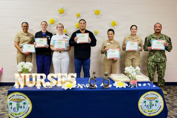 2026 DAISY Award nominees and winners pose for a group photo during a recognition ceremony at Naval Hospital Twentynine Palms May 12, 2026. Pictured from left to right are Lt. Yvonne Maginley, Lt. Isabel M. Jackabon, Lt. Corinne Hassett, Lt. j.g. Aaron Gacaad, Lt. Cmdr. Jassette Fong, Lt. j.g. Marisela Ferguson and Lt. j.g. Duane Aldous V. Daquioag. The DAISY Award honors nurses who demonstrate extraordinary compassion, clinical excellence and dedication to patient-centered care. (U.S. Navy photo by Christopher Jones, NMRTC / NH Twentynine Palms public affairs officer)